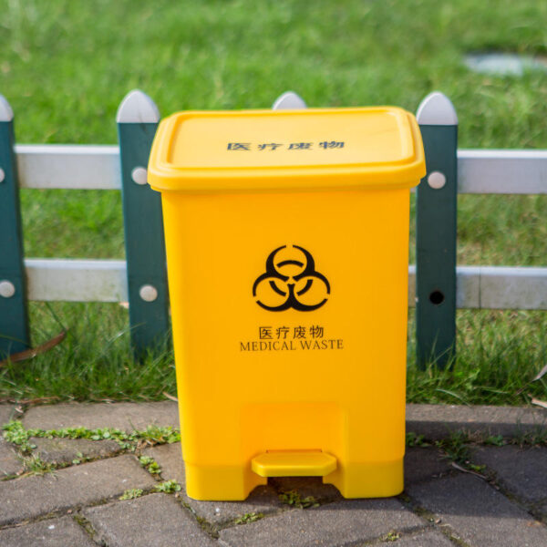 Plastic medical waste bin with foot