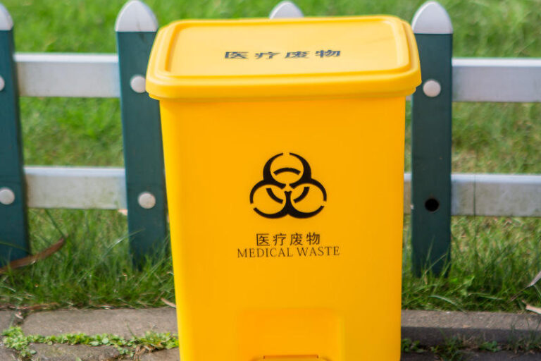Plastic medical waste bin with foot