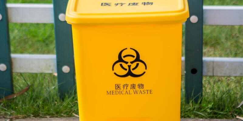 Plastic medical waste bin with foot